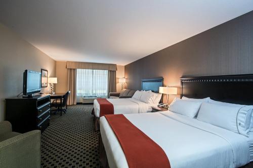 a hotel room with two beds and a television at Holiday Inn Express & Suites - Green Bay East by IHG in Green Bay