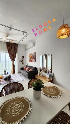 a living room with a table and chairs and a couch at Rumah No 3 Youth City Residence Nilai in Nilai