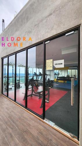 a building with large windows with a view of the ocean at Rumah No 3 Youth City Residence Nilai in Nilai