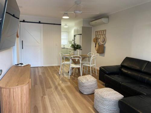a living room with a couch and a table at 'Rocks Retreat' - Dunbar Court Unit 2 - Renovated & Centrally Located in South West Rocks