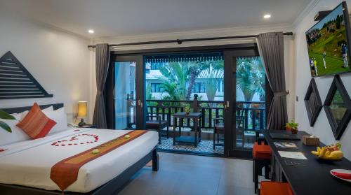 a bedroom with a bed and a balcony at Khmer Mansion Boutique Hotel in Siem Reap
