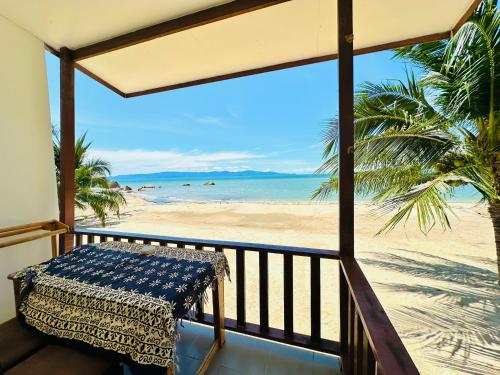 a balcony with a view of the beach at The Scenery Beach Resort in Baan Khai