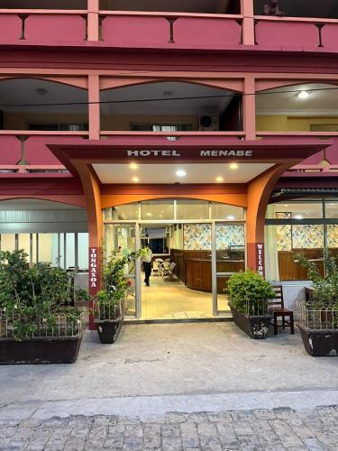a hotel entrance with plants in front of it at HOTEL MENABE in Morondava