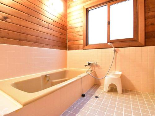 a bathroom with a bath tub and a toilet at ヴィータ牛窓 in Setouchi