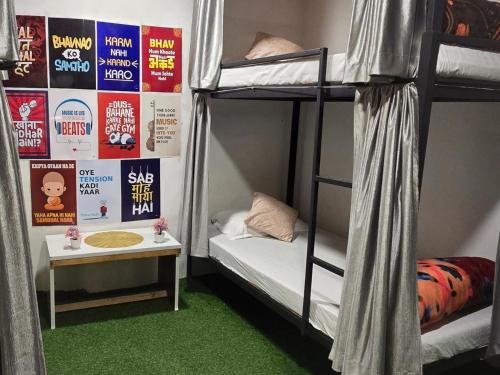a room with two bunk beds and a table at THE BUNK STREET in Manāli