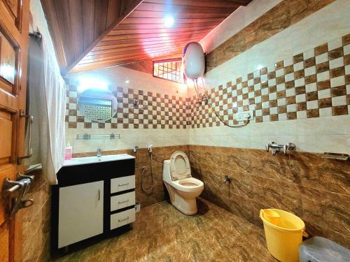 a bathroom with a toilet and a sink at Pine Paradise Homestay in Shimla