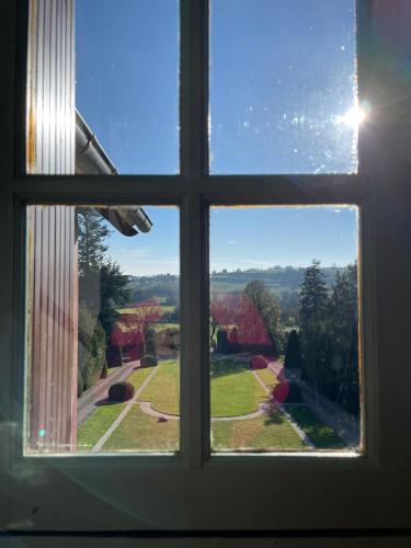 a window view of a yard from a house at Domaine des Thomins in Cisai-Saint-Aubin