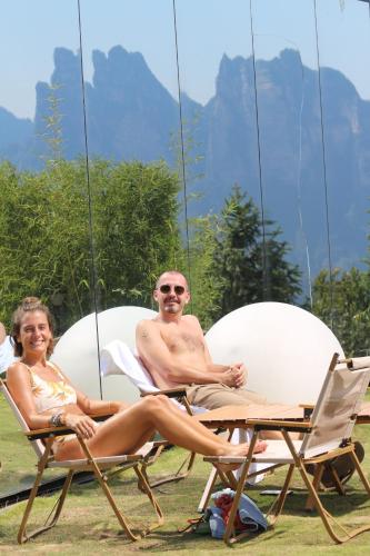 a man and a woman sitting on lawn chairs at XMAN Sunrise Peaks Resort--Free Pick-up in Zhangjiajie