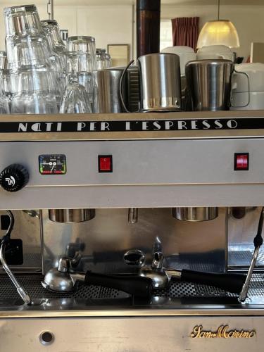 a coffee machine in a kitchen with pots and pans at Taringatura Backpackers in Pukearuhe