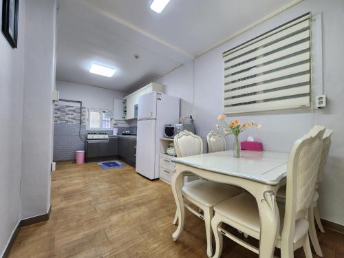 a kitchen and dining room with a table and chairs at Daemyeongyeok - house of gallery in Daegu
