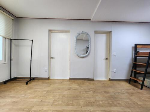 a room with two doors and a mirror on the wall at Daemyeongyeok - house of gallery in Daegu