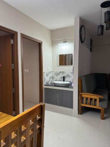 a living room with a couch and a sink at Aami dhivahi guest house 01 in Trivandrum