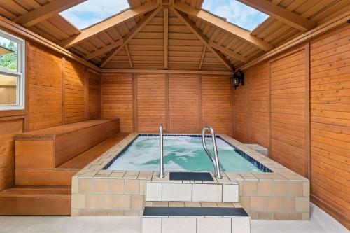 an indoor hot tub in a room with wooden walls at Quality Inn & Suites Vancouver - Hazel Dell in Vancouver