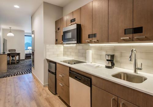 a kitchen with a sink and a microwave at Hyatt House Bwi Airport/Baltimore in Linthicum Heights