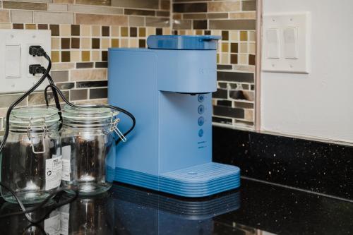 a blender on a counter with two glass jars at 74L - 2BR Quincy - Cozy Couple Hideout near Wollaston Beach in Quincy