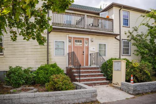 a house with a orange door and a balcony at 74L - 2BR Quincy - Cozy Couple Hideout near Wollaston Beach in Quincy
