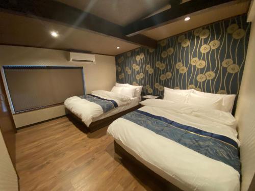 Ένα ή περισσότερα κρεβάτια σε δωμάτιο στο 京町家ゲストハウス遥月