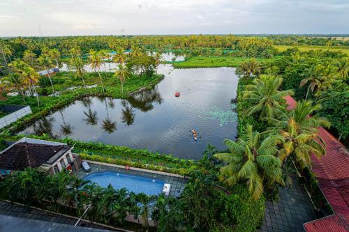 an aerial view of a river with palm trees at Kumarakom Park Resort in Kumarakom
