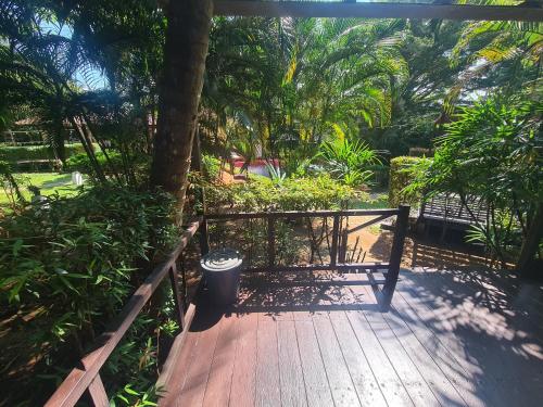 a wooden walkway with a gate and a trash can at Red Moon Hideaway in Ko Chang