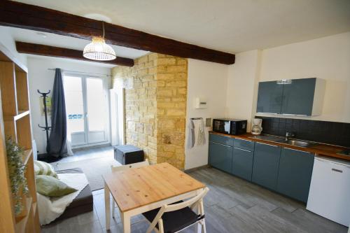 a kitchen with a wooden table in a room at Agora, au cœur historique in Montpellier
