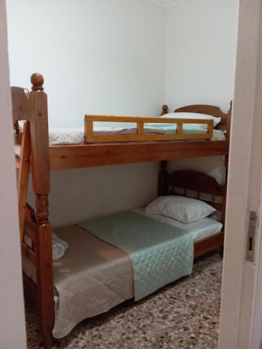 Wooden bunk bed in a dorm 5' from metro