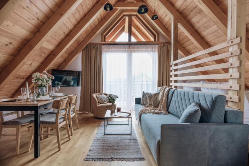 a living room with a blue couch and a table at Apres Ski Bachleda - LoftAffair Collection in Zakopane