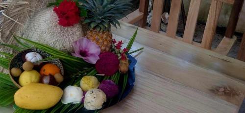 a bowl of fruits and vegetables on a wooden bench at Camotes-Hidden-Huts in San Francisco
