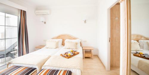 a bedroom with two beds with stuffed animals on them at Ona Village Cala d'Or in Cala d´Or