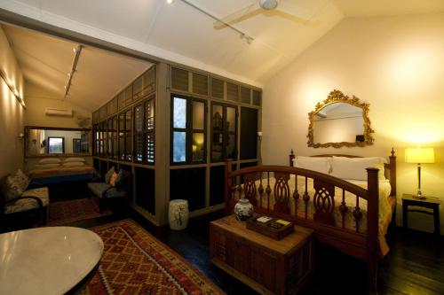 a living room with a bed and a table at Muntri Mews in George Town