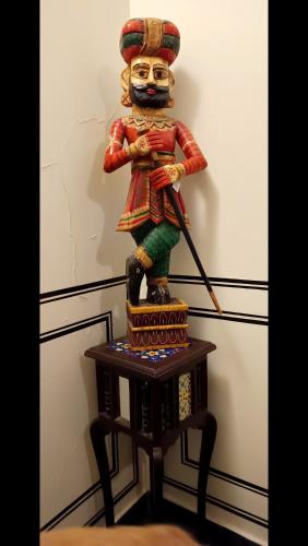 a statue of a samurai sitting on a table at Little Ganesha Inn in Jaipur
