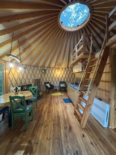 a room with a yurt with a table and a ladder at FORGLAMP in Bydgoszcz