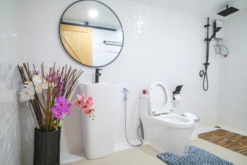 a bathroom with a mirror and a toilet at Nangyuan Island Dive Resort in Koh Tao