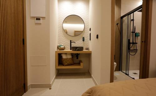 a bathroom with a sink and a mirror on a wall at Hotel Puerto de Luarca in Luarca