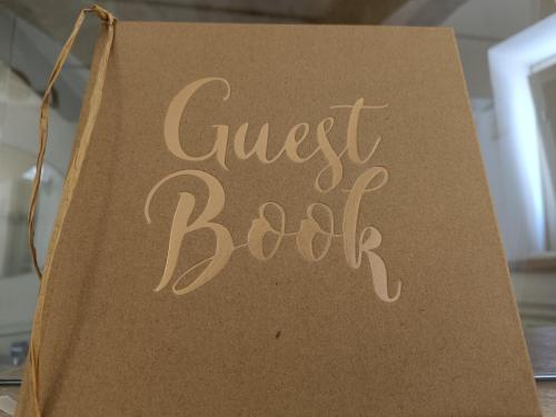 a sign that says guest book hanging on a table at Casa Felda in Altamura
