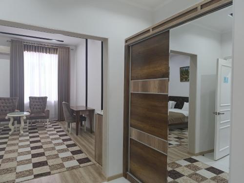 a sliding door in a room with a bedroom at GRAND SARBON HOTEL in Qarshi