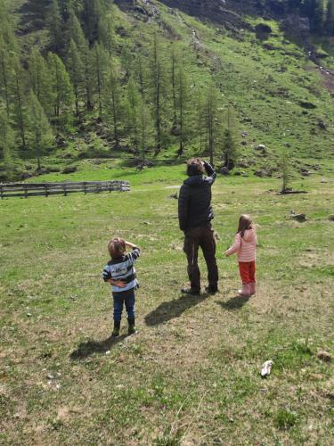 a man and two children standing in a field at Obenfigerhof in Kals am Großglockner