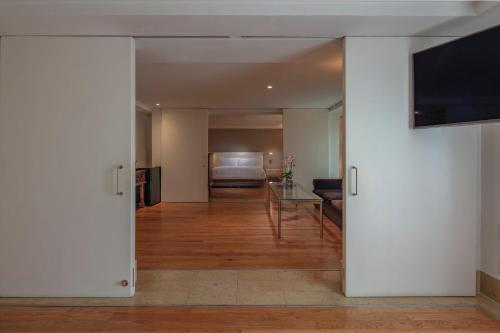 a living room with a couch and a television at Presidente InterContinental Puebla by IHG in Puebla