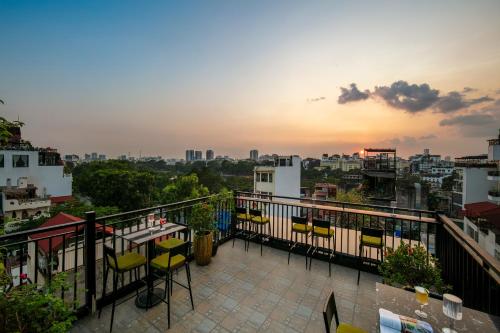 a balcony with chairs and a view of the city at TrangTrang Luxury Hotel in Hanoi