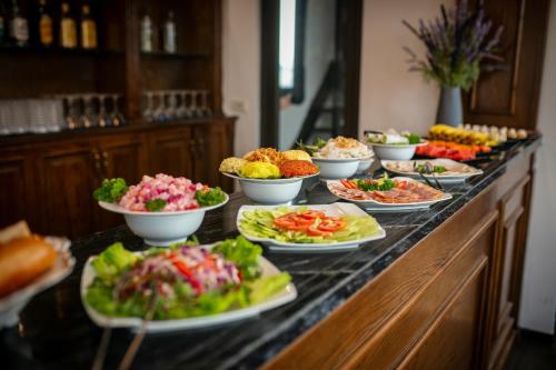 a buffet with many plates of food on a table at TrangTrang Luxury Hotel in Hanoi