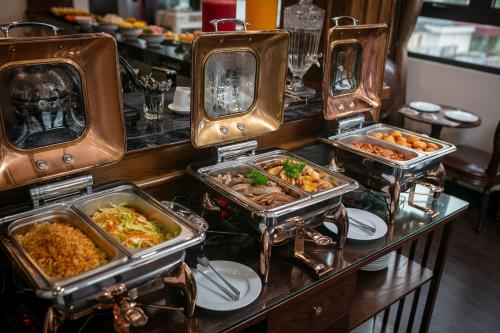 a buffet with several trays of food on a table at TrangTrang Luxury Hotel in Hanoi