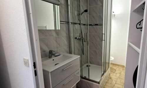 une salle de bain avec une douche en verre et un lavabo dans l'établissement Studio Cosy ,2pers, cosy douillet, 3mn mer, à La Grande Motte