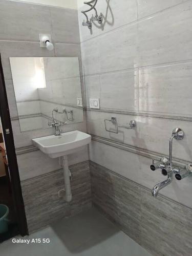 a bathroom with a sink and a mirror at Palm Vista Vacations Barkur Udupi District in Bārkūr