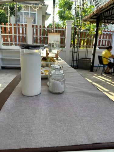 a table with a cup and a plate of food at Venn Hostel in Vientiane