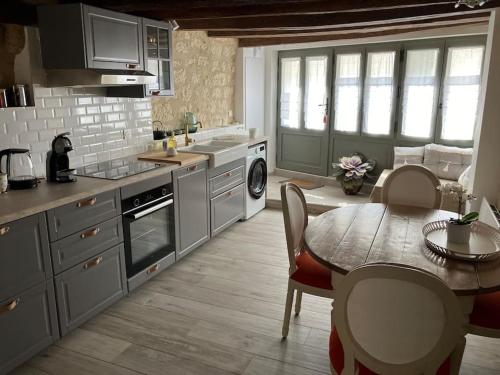 a kitchen with a table and a dining room at Maison Centre de Loches in Loches