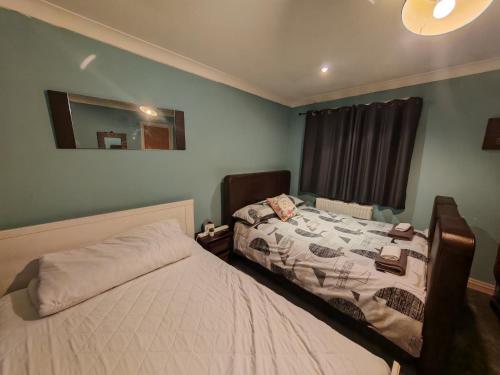 a bedroom with a bed and a mirror at king size bed -Room near Bournemouth Hospital shared bathroom in Bournemouth