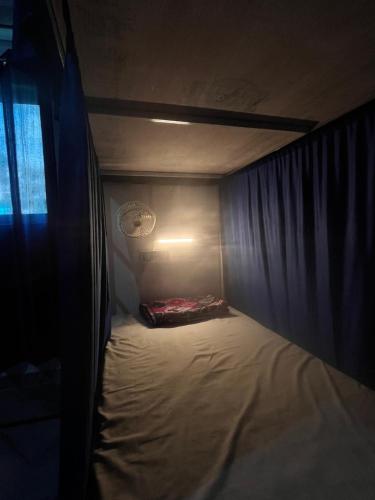 a small bed in a small room with a window at The GreenView HomeStay in Rishīkesh