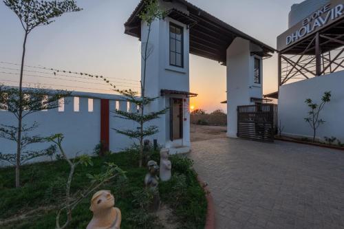 a white building with a sunset in the background at Evoke Dholavira in Dholovira