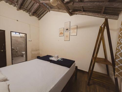 a bedroom with a bed in a room at Sunset Cafe Beach Stay in Gokarna