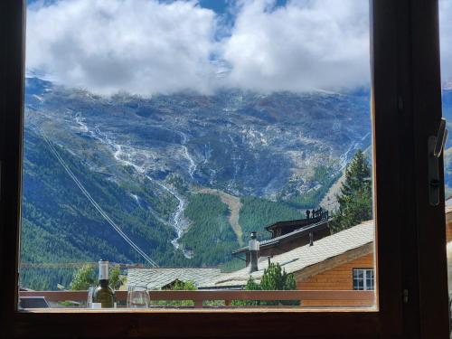 a view of a mountain from a window at Hotel Etoile & Alpenperle Residences in Saas-Fee
