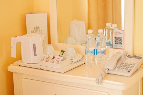 a counter with a telephone and bottles of water on it at СПА-Готель "RESPECT" in Skhidnitsa